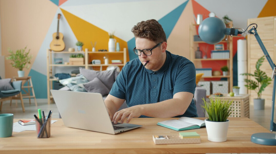 young professional working on laptop at home